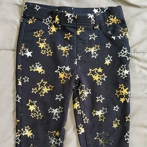 Black stretchy jeans leggings with gold, silver, and white stars